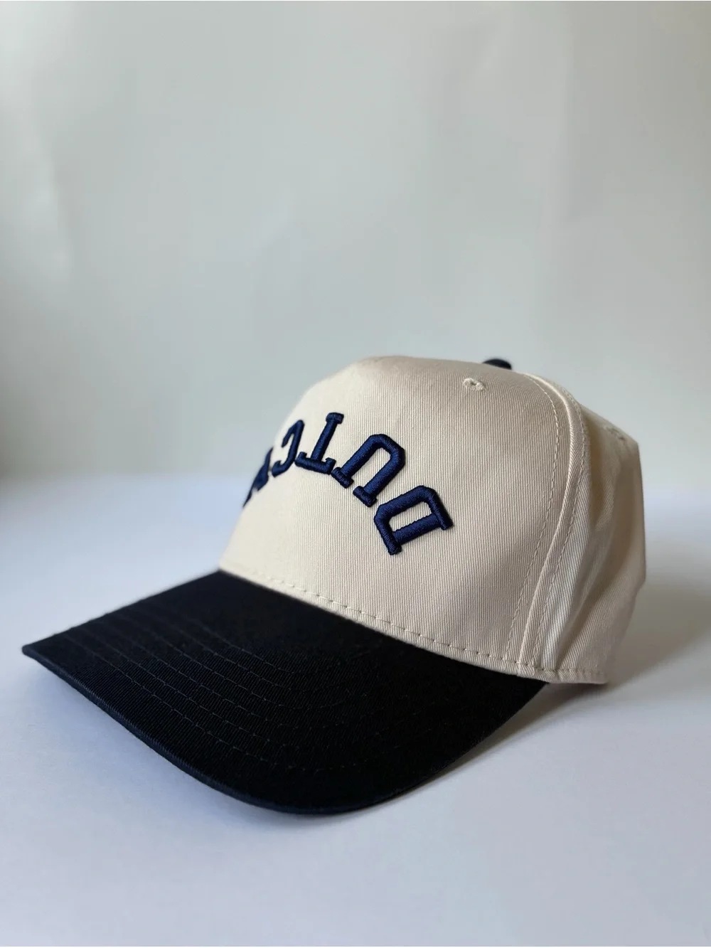 Dutch Bros Upside Down SnapBack Hat- Cream & Navy